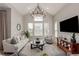Vaulted living room with natural light, stylish decor, and a modern chandelier at 16762 Tejon Ln, Broomfield, CO 80023