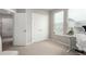 A view of a light-filled office with double doors, window, and a desk at 16762 Tejon Ln, Broomfield, CO 80023