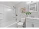 The bathroom is equipped with a shower-tub, toilet and white vanity at 7700 W Glasgow Pl # 10A, Littleton, CO 80128