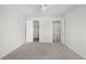 Neutral bedroom with ceiling fan and doorways leading to closet and hallway at 7700 W Glasgow Pl # 10A, Littleton, CO 80128
