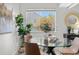 Bright dining area with a glass table, stylish chairs, and a view of outside at 7700 W Glasgow Pl # 10A, Littleton, CO 80128