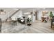 Stylish living room with modern furniture, sleek staircase, and light wood flooring at 7700 W Glasgow Pl # 10A, Littleton, CO 80128