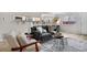 Bright living room with a comfortable sofa and a partial view of the dining area at 7700 W Glasgow Pl # 10A, Littleton, CO 80128