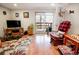 Finished basement with laminate floors, a large TV, and access to the outdoors at 8624 S Doubleheader Ranch Rd, Morrison, CO 80465