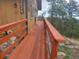 View of wood deck with surrounding view of trees and a partial view of a possible mountain at 8624 S Doubleheader Ranch Rd, Morrison, CO 80465