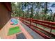 Red wood deck with seating and workout space, perfect for outdoor relaxation at 8624 S Doubleheader Ranch Rd, Morrison, CO 80465