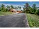 Long driveway leads to a cabin home nestled among trees, with a detached garage at 8624 S Doubleheader Ranch Rd, Morrison, CO 80465