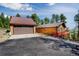 Cozy cabin home with a detached garage and beautiful mountain views from the elevated deck at 8624 S Doubleheader Ranch Rd, Morrison, CO 80465