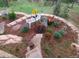 Landscaped garden with bench seating, stone borders, flower arrangements, and steps at 8624 S Doubleheader Ranch Rd, Morrison, CO 80465