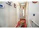 Hallway featuring hardwood floors, neutral paint, and access to multiple rooms at 8624 S Doubleheader Ranch Rd, Morrison, CO 80465