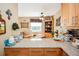 Well-appointed kitchen with granite countertops and cabinetry with dining area in the background at 8624 S Doubleheader Ranch Rd, Morrison, CO 80465