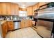An updated kitchen features stainless steel appliances, granite countertops, and abundant cabinetry at 8624 S Doubleheader Ranch Rd, Morrison, CO 80465