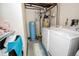 Well-equipped laundry room with washer, dryer, and storage including water softener, for streamlined chores at 8624 S Doubleheader Ranch Rd, Morrison, CO 80465