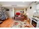 Cozy living room with a fireplace, decorative rug, and a Christmas tree offering a relaxing space for entertaining at 8624 S Doubleheader Ranch Rd, Morrison, CO 80465