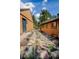 Charming walkway between houses with stepping stones, natural landscaping and vibrant flowers at 8624 S Doubleheader Ranch Rd, Morrison, CO 80465