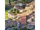 Landscaped yard featuring stone borders, bridge, stone steps, bench, and other garden elements at 8624 S Doubleheader Ranch Rd, Morrison, CO 80465