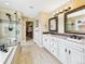 Luxurious bathroom with dual sinks, walk-in shower, and walk-in closet, offering convenience and style at 784 Sweet Pine Ct, Monument, CO 80132