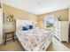 Bright bedroom featuring a floral-patterned bed, white furniture and natural light from the window at 784 Sweet Pine Ct, Monument, CO 80132
