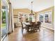 Bright dining room with hardwood floors, modern chandelier, and multiple windows providing ample natural light at 784 Sweet Pine Ct, Monument, CO 80132