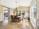 Dining room with chandelier, hardwood floors, and views of fenced back yard at 784 Sweet Pine Ct, Monument, CO 80132