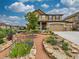 Inviting two-story home with a covered porch, three-car garage, and landscaped front yard at 784 Sweet Pine Ct, Monument, CO 80132