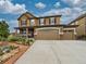 Inviting two-story home with a covered porch, three-car garage, and landscaped front yard at 784 Sweet Pine Ct, Monument, CO 80132