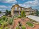 Inviting two-story home with a covered porch, three-car garage, and landscaped front yard at 784 Sweet Pine Ct, Monument, CO 80132