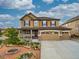 Stunning two-story home showcasing a charming facade, three-car garage, and beautifully landscaped front yard at 784 Sweet Pine Ct, Monument, CO 80132
