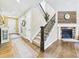 Elegant foyer with a staircase, hardwood floors, stone fireplace, and stylish decor creating a welcoming entrance at 784 Sweet Pine Ct, Monument, CO 80132