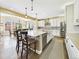 Spacious open kitchen with stainless steel appliances, central island, barstool seating, and view to dining area at 784 Sweet Pine Ct, Monument, CO 80132