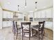 Gourmet kitchen featuring a large center island with seating, white cabinetry, and modern appliances at 784 Sweet Pine Ct, Monument, CO 80132