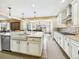 Open concept kitchen with large island, stainless steel dishwasher, and flow into dining area at 784 Sweet Pine Ct, Monument, CO 80132