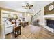 Spacious living room featuring a fireplace, hardwood floors, and seamless transition to the kitchen and dining areas at 784 Sweet Pine Ct, Monument, CO 80132