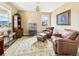 Comfortable living room featuring leather seating, a decorative rug, and ample natural light at 784 Sweet Pine Ct, Monument, CO 80132