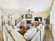 Bright living room with a fireplace, hardwood floors, and a large sofa creating an inviting and comfortable space at 784 Sweet Pine Ct, Monument, CO 80132