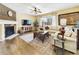 Cozy living room with a stone fireplace, hardwood floors, and a comfortable sofa, perfect for relaxing at 784 Sweet Pine Ct, Monument, CO 80132