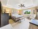 Comfortable main bedroom with a tray ceiling, ceiling fan, and ample natural light for a relaxing retreat at 784 Sweet Pine Ct, Monument, CO 80132