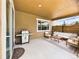 Covered patio featuring a grill, white furniture, and stylish outdoor decor at 784 Sweet Pine Ct, Monument, CO 80132