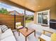 Relaxing covered patio area with comfortable seating and a view of the backyard at 784 Sweet Pine Ct, Monument, CO 80132
