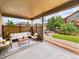 Covered patio with outdoor seating area and view of fenced backyard at 784 Sweet Pine Ct, Monument, CO 80132