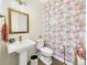 Half bath with a pedestal sink, statement wallpaper, and designer fixtures at 784 Sweet Pine Ct, Monument, CO 80132