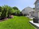 Spacious backyard with lush greenery, patio, and garden beds, creating a peaceful outdoor oasis at 20789 E Princeton Pl, Aurora, CO 80013