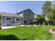 Backyard of a home featuring a patio, manicured lawn, and outdoor seating at 20789 E Princeton Pl, Aurora, CO 80013