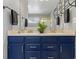 Elegant bathroom with double vanity, modern fixtures, and stylish blue cabinetry at 20789 E Princeton Pl, Aurora, CO 80013