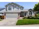 Charming two-story home featuring an attached garage, a manicured lawn, and beautiful landscaping at 20789 E Princeton Pl, Aurora, CO 80013