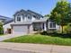 Charming two-story home featuring an attached garage, a manicured lawn, and beautiful landscaping at 20789 E Princeton Pl, Aurora, CO 80013