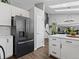 Bright, modern kitchen with white countertops, cabinets, and black stainless steel refrigerator at 20789 E Princeton Pl, Aurora, CO 80013