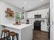 Modern kitchen with white subway tile, countertops, island, and black stainless steel appliances at 20789 E Princeton Pl, Aurora, CO 80013