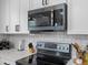 Close-up of kitchen area showcasing black stainless steel appliances and white countertops at 20789 E Princeton Pl, Aurora, CO 80013