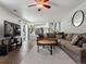 Open living room with gray sectional sofa, TV, and view to the kitchen at 20789 E Princeton Pl, Aurora, CO 80013